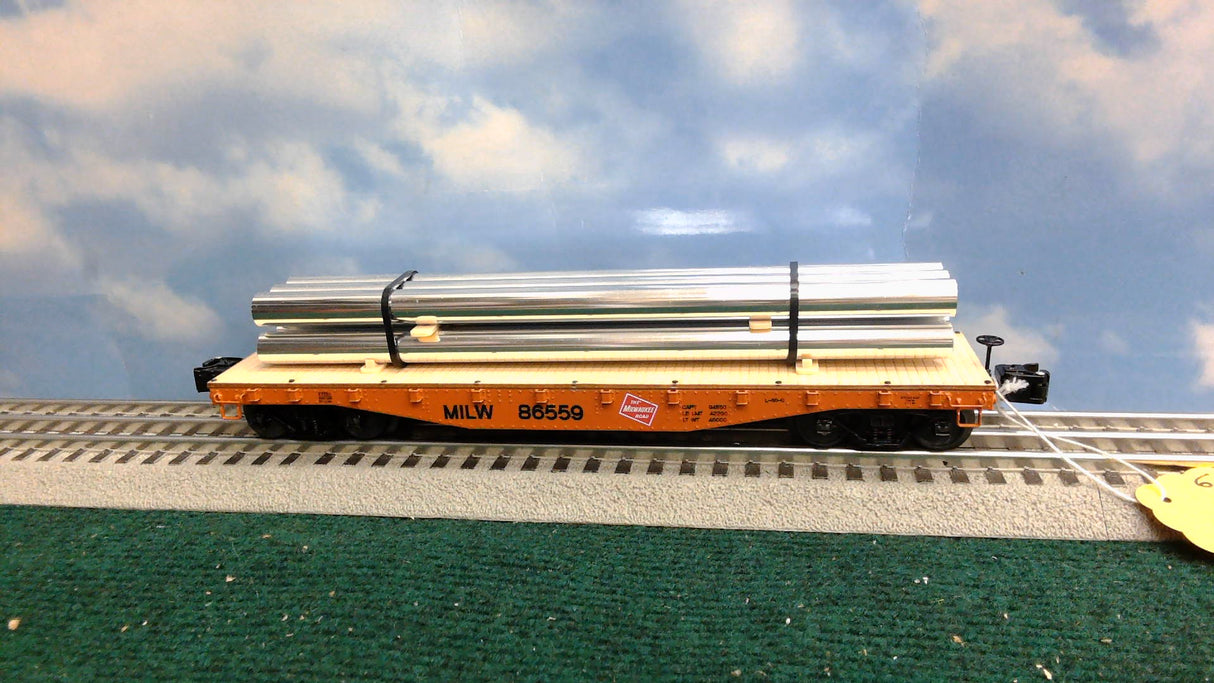 Lionel 6-27824 Milwaukee Road 40' Flatcar with Metal Pipes #86559